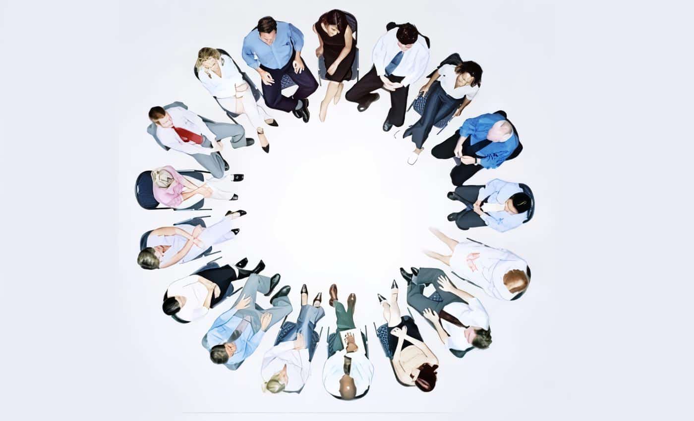 Group of people sitting in circle, overhead view